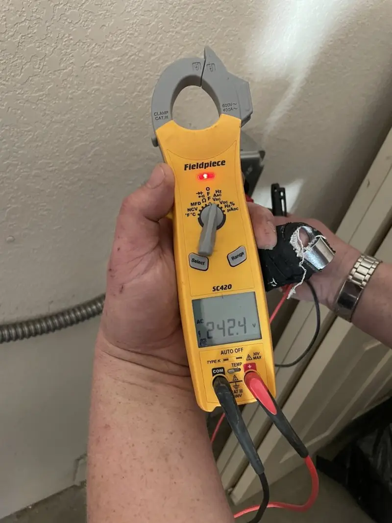 Voltage testing with clamp meter during Whole House Surge Protector in San Leon